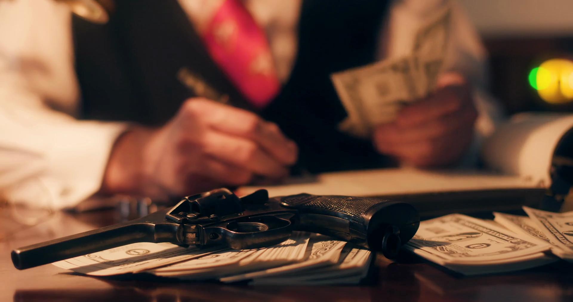1920 x 1013 · png - 40s gangster writing in ledger focus on pistol and money 4k Stock Video ...